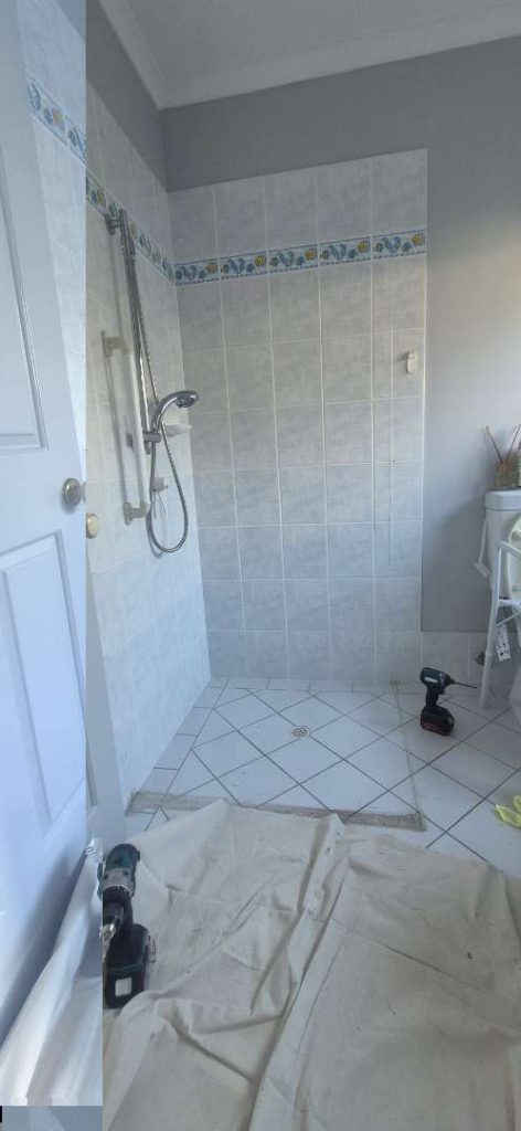 White tiled bathroom after plumbing work