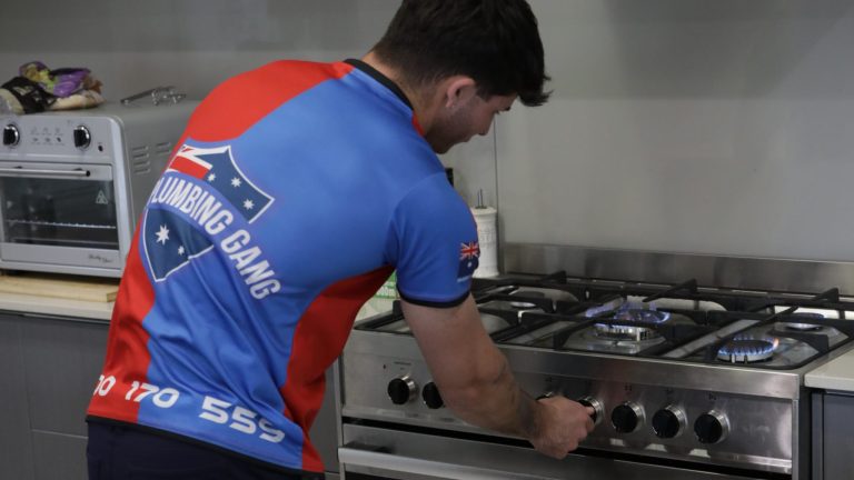 Gasfitter installing a gas cooktop