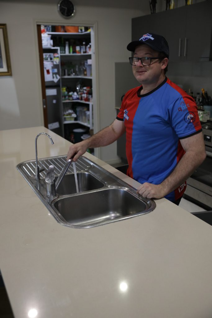 Plumber fitting a double kitchen sink