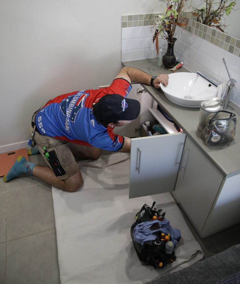 Plumber installing a toilet suite