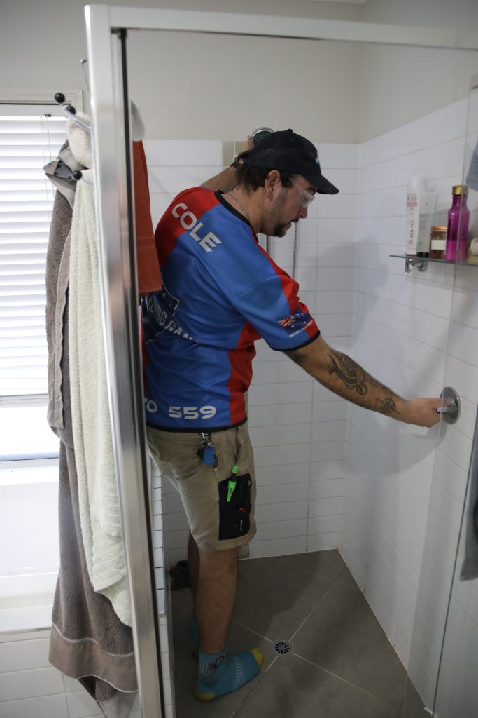 Plumber repairing a shower mixer