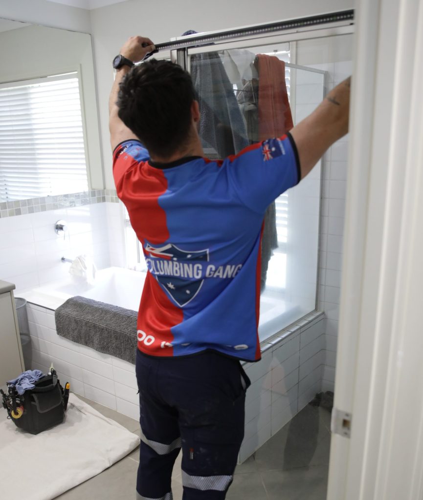 Plumber fitting a shower head
