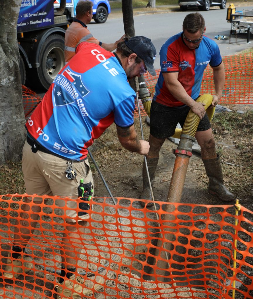 Plumbing crew repairing a sewer line