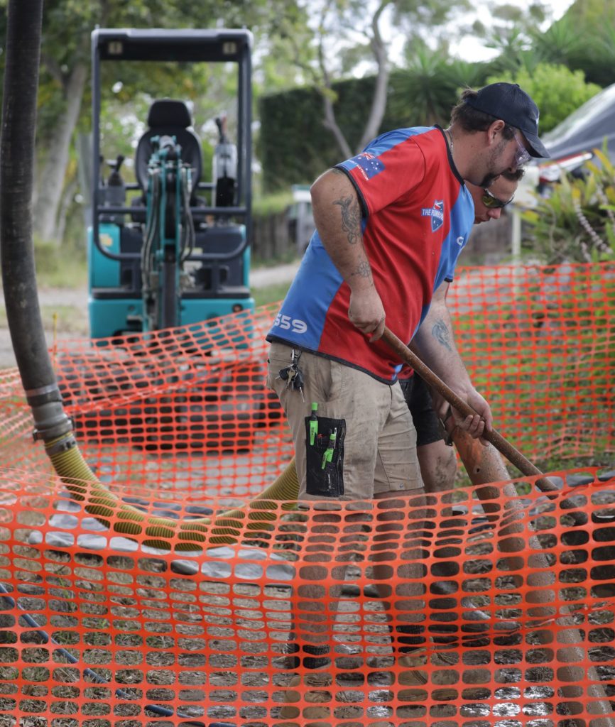 Plumber working at an excavated drain