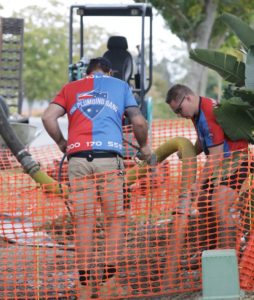 Plumbers working on a drain excavation