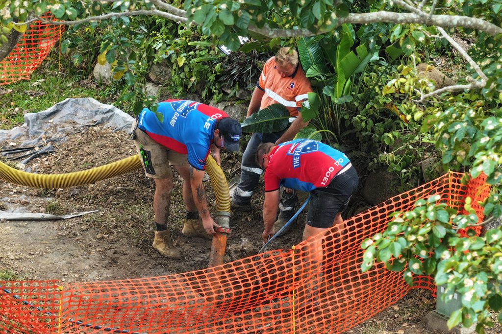 Plumbers excavating to repair a blocked drain