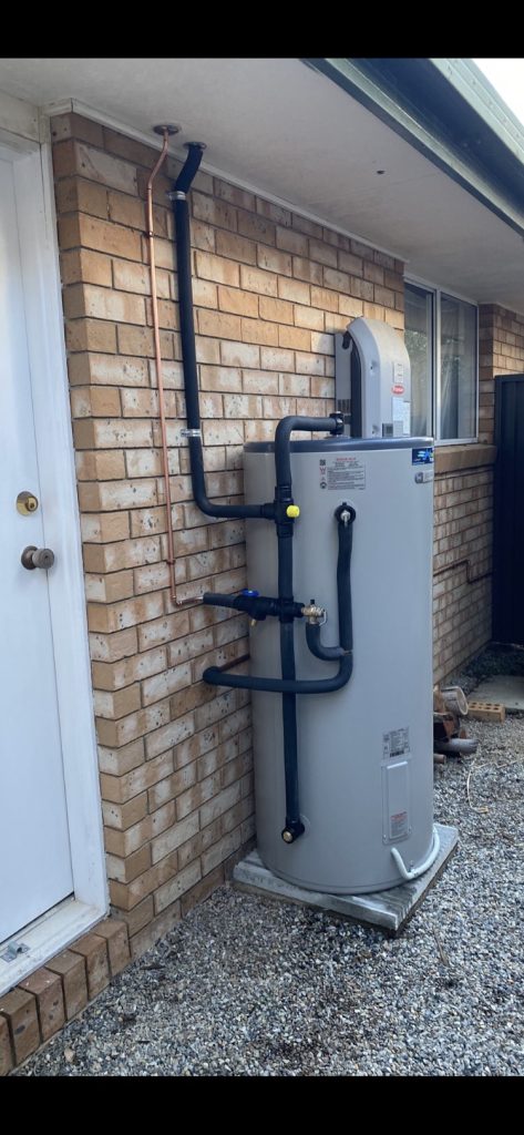 Gas hot water unit and pipework on an exterior wall
