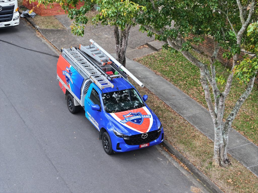 Aerial view of a Plumbing Gang ute on the road