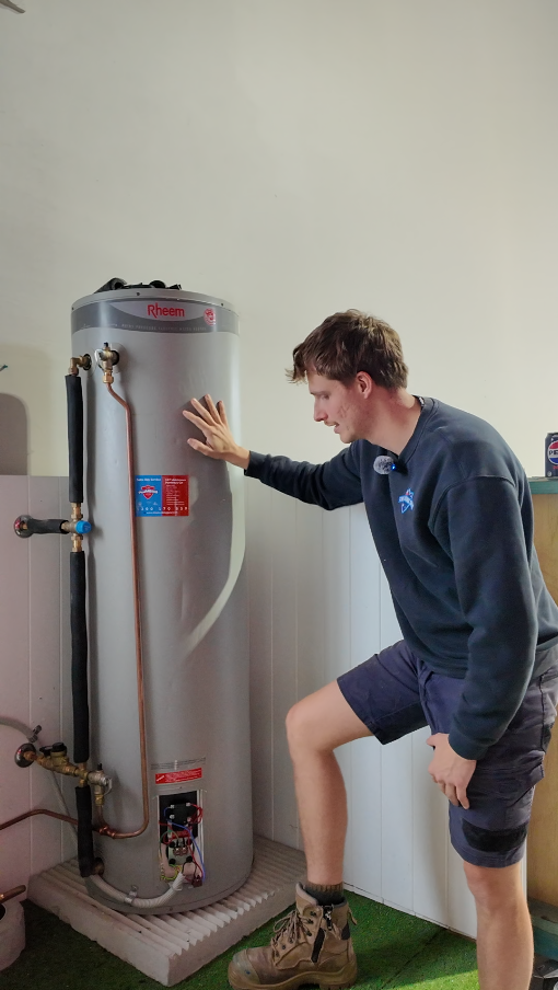 Plumber testing a hot water system outside