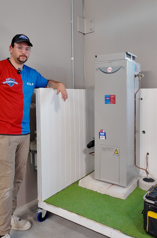 Plumber with a heat pump hot water installation