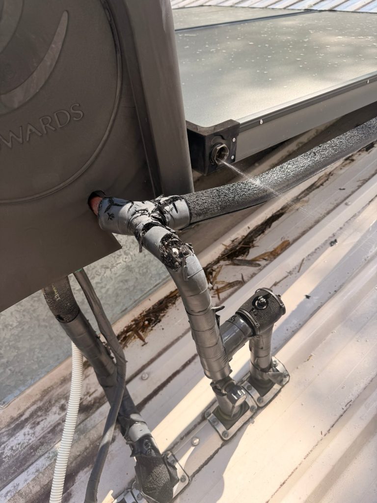 Water spraying from a burst copper pipe connection