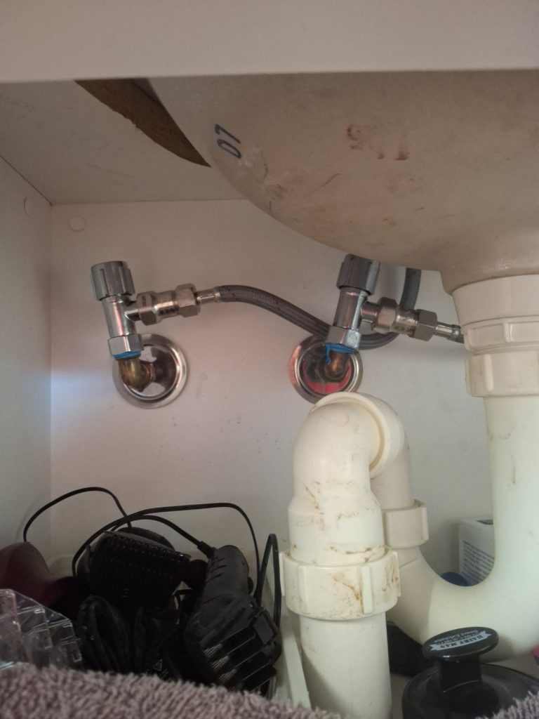 New flexi hoses and mini stop taps under a vanity