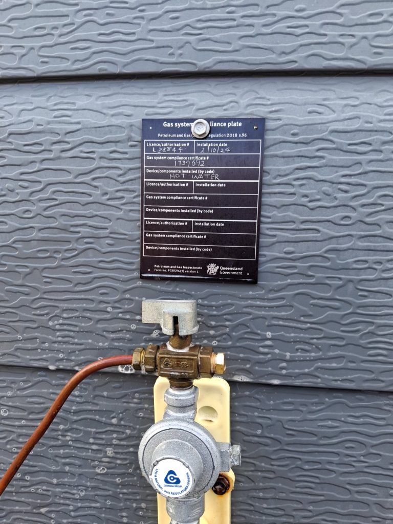Gas compliance plate and regulator at a gas meter