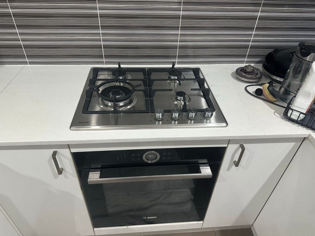 Gas cooktop and oven installed in a kitchen