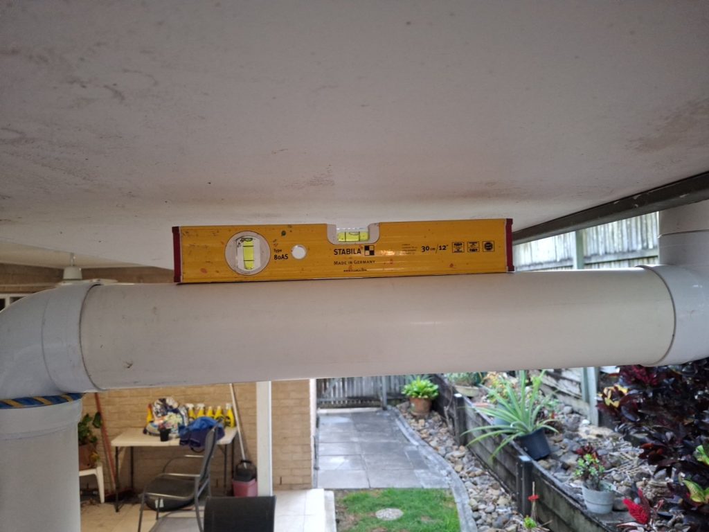 New gutter being levelled during a gutter replacement