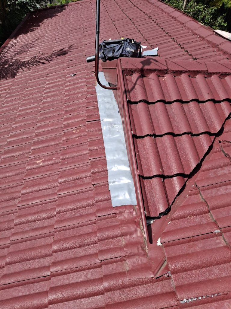 Roof leak repaired with new flashing on a tiled roof