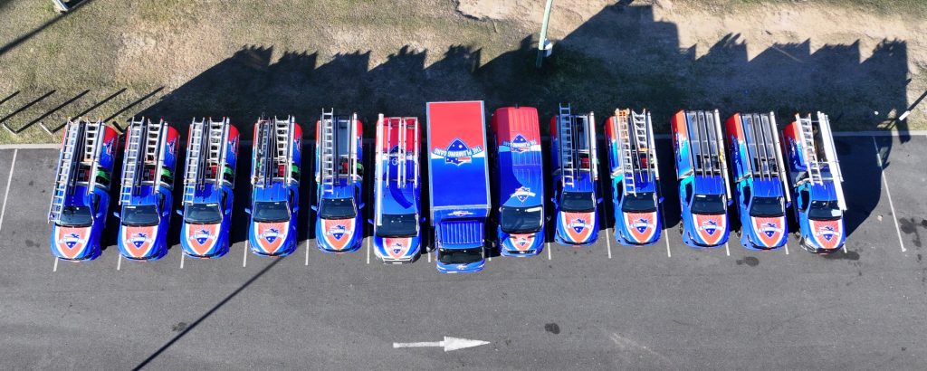 The Plumbing Gang fleet of branded vans and utes, aerial view