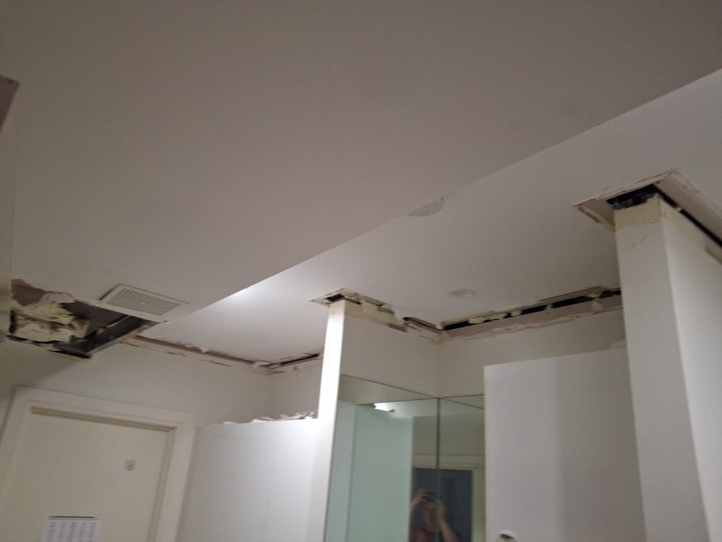 Ceiling cut open to inspect water damage for an insurance report